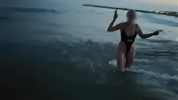Blonde shows tits and sucks cock on a public beach