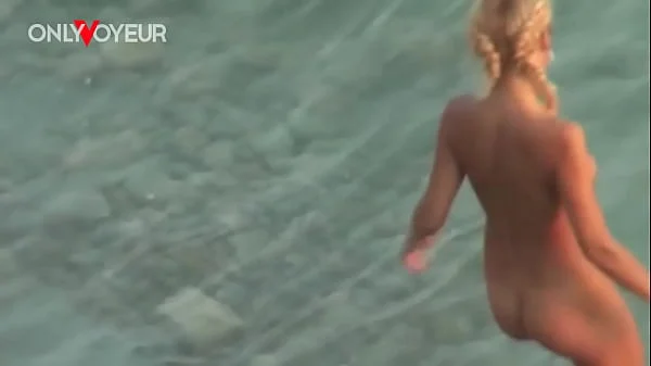 Beach Voyeur. Gorgeous blonde babe riding her man on a public beach