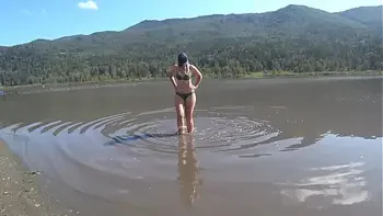 Juicy booty in shorts goes outdoors, changes clothes in a public booth on the beach, bathes and sunbathes. Fetish with peeping.