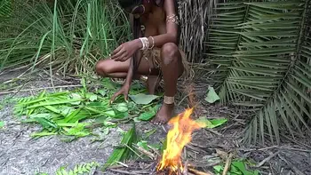 Hot African native woman cooking in the jungle