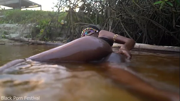Skinny dark skinned African hottie teasing in the water