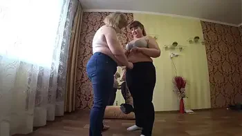 Sexual foreplay of two mature lesbians with fat asses, gradual undressing and caress.