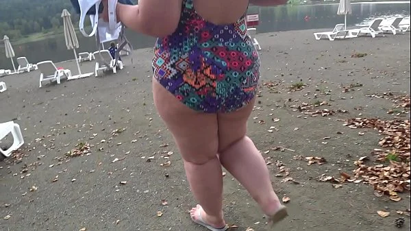 BBW with big booty in tight jeans is dressing in a public dressing room on the beach. Fetish.