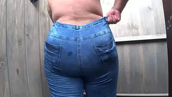 BBW with big booty in tight jeans is dressing in a public dressing room on the beach. Fetish.