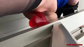 Busty mature Red XXX fucks her dildo on the stairs