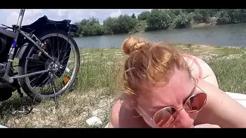 The sexy bitch sits on the beach and then he gives her a blowjob part 2