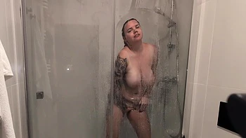 The Girl With Big Tits Takes A Shower And Masturbates