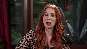 The red head Madison Morgan shows her assets in a captivating video