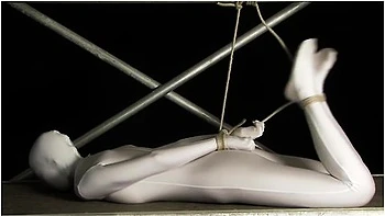 Babe Wrapped In White Zentai Suit Enjoys To Be Bondaged To A Metal Pole