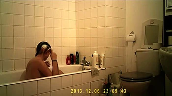 Brunette cutie enjoys a hot shower in the bathroom